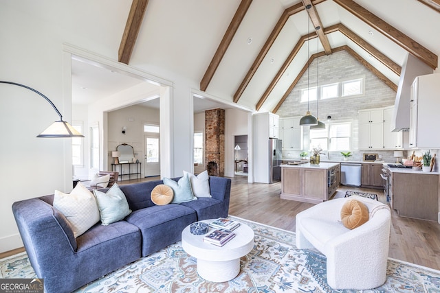 living room featuring high vaulted ceiling, beam ceiling, and light wood-type flooring