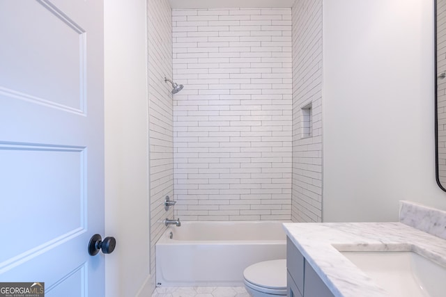 full bathroom with toilet, tiled shower / bath, and vanity