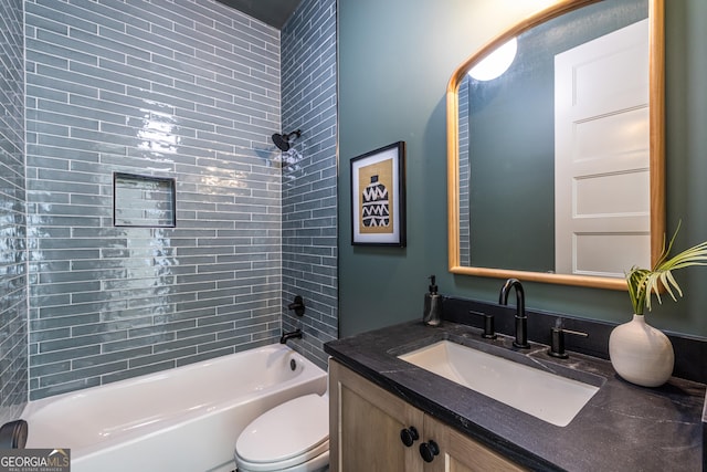 full bathroom featuring toilet, tiled shower / bath, and vanity