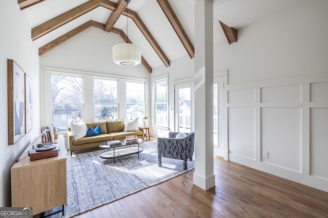 interior space with dark hardwood / wood-style flooring, beam ceiling, and high vaulted ceiling