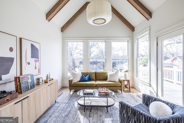 sunroom / solarium featuring vaulted ceiling with beams