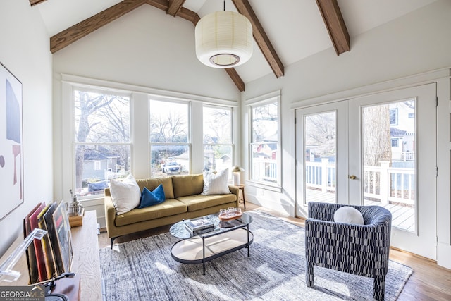 sunroom with vaulted ceiling with beams and french doors