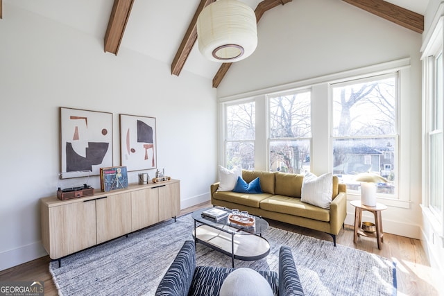 living room featuring high vaulted ceiling, beam ceiling, plenty of natural light, and hardwood / wood-style floors