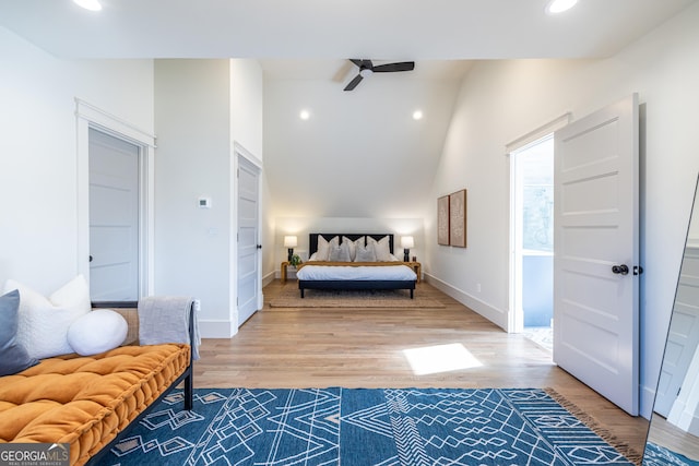 bedroom with vaulted ceiling and hardwood / wood-style flooring