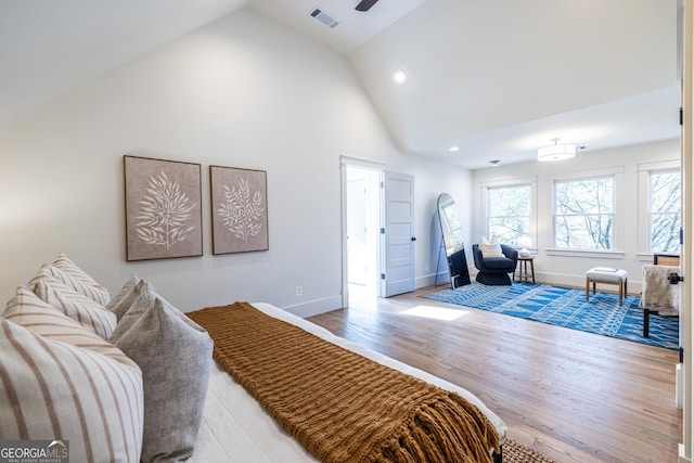 bedroom featuring hardwood / wood-style floors and high vaulted ceiling