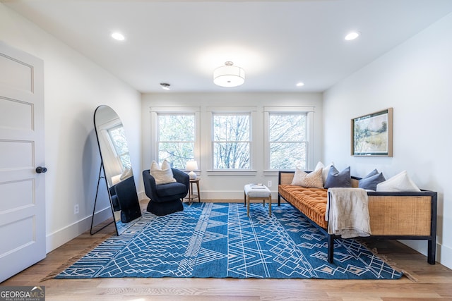 living area with a healthy amount of sunlight and hardwood / wood-style floors