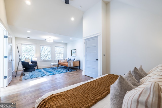 bedroom with light hardwood / wood-style flooring and high vaulted ceiling