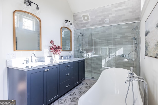 bathroom featuring vanity, vaulted ceiling, and independent shower and bath