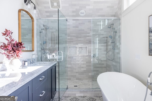 bathroom featuring vanity and separate shower and tub