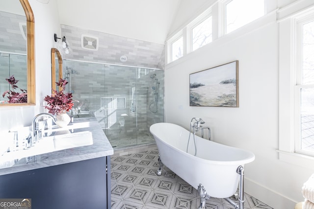 bathroom featuring lofted ceiling, vanity, and independent shower and bath