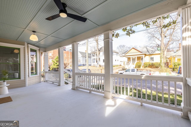 unfurnished sunroom with ceiling fan and plenty of natural light