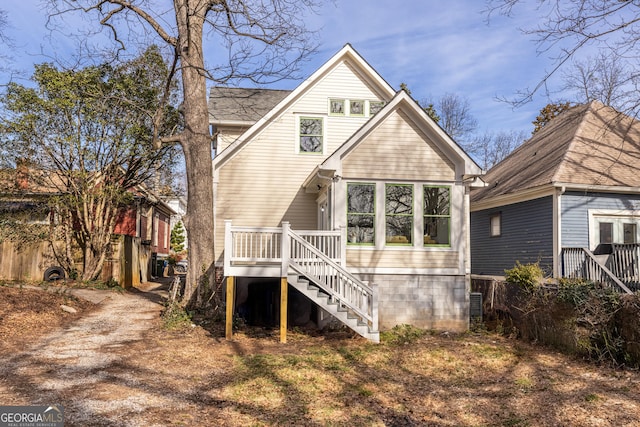 rear view of property featuring a wooden deck