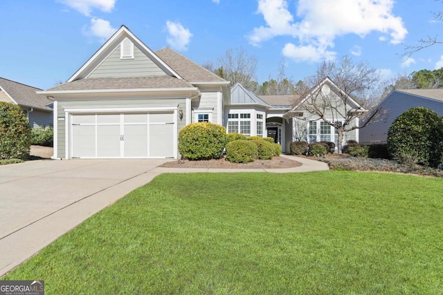 view of front of house featuring a front lawn and a garage