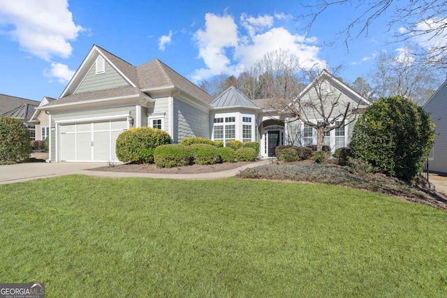 view of front of property featuring a front lawn and a garage