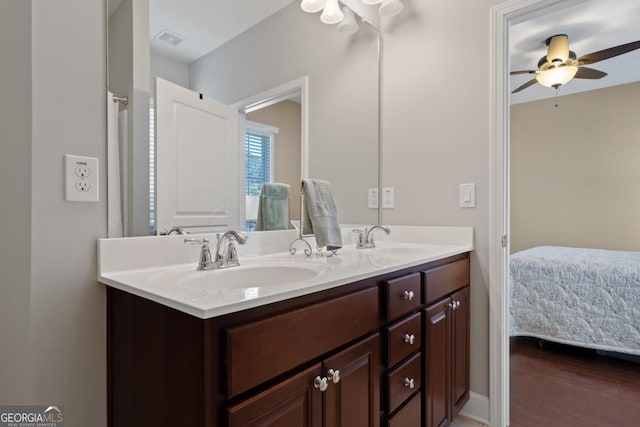 bathroom with wood-type flooring, vanity, and ceiling fan