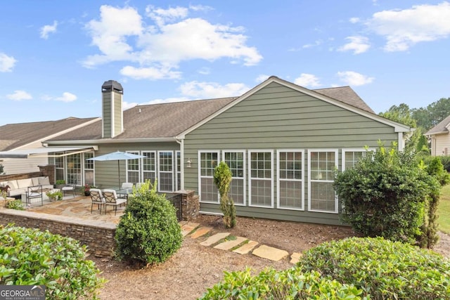 rear view of property featuring an outdoor hangout area and a patio