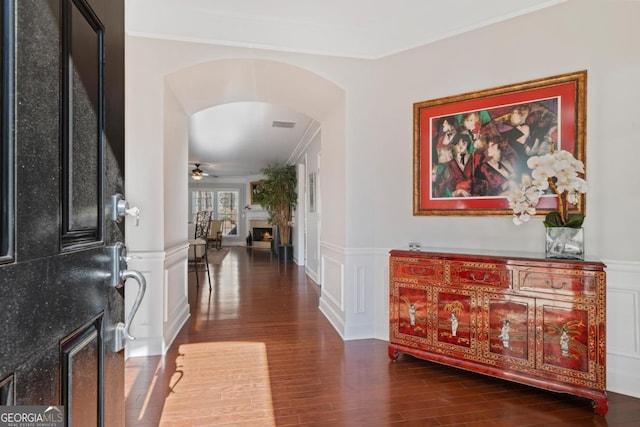 entrance foyer featuring ceiling fan, ornamental molding, and dark hardwood / wood-style floors