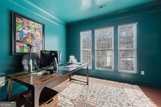 office space with wood-type flooring and crown molding