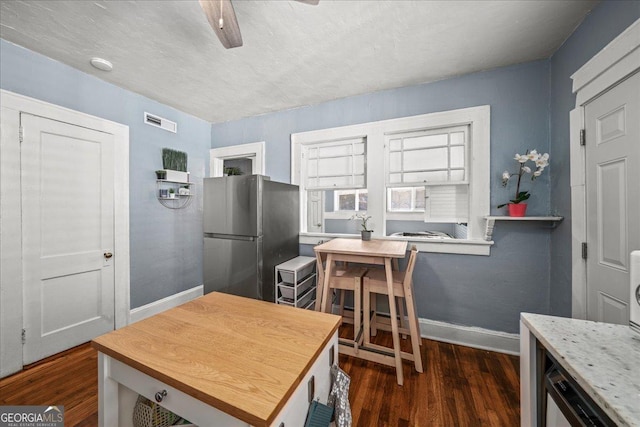 kitchen featuring ceiling fan, a textured ceiling, stainless steel fridge, and dark hardwood / wood-style floors