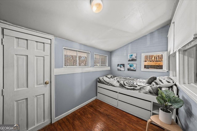 bedroom with vaulted ceiling and dark hardwood / wood-style floors