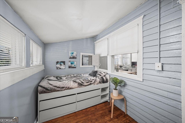 bedroom with lofted ceiling and dark hardwood / wood-style floors