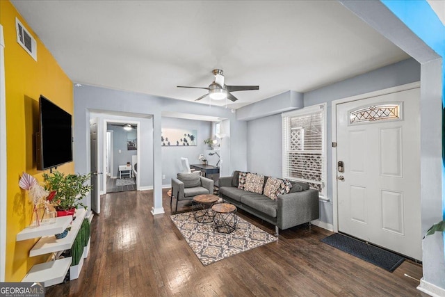 living room with ceiling fan and dark hardwood / wood-style floors