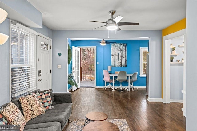 living room featuring ceiling fan and dark hardwood / wood-style floors