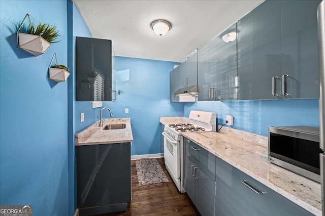 kitchen featuring light stone countertops, gas range gas stove, dark hardwood / wood-style floors, and sink