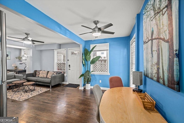 living room with ceiling fan and dark hardwood / wood-style floors