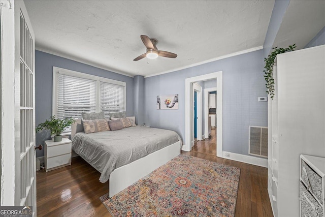 bedroom with ceiling fan, dark wood-type flooring, and crown molding