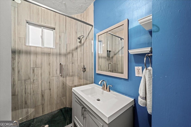 bathroom with vanity and a shower with door