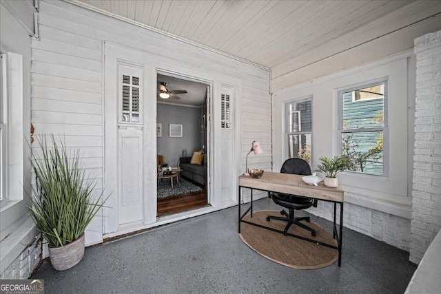 office area featuring wood walls