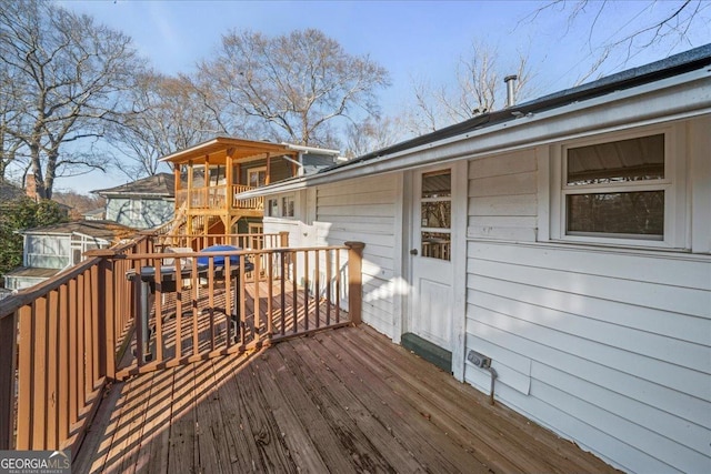 wooden deck featuring a playground