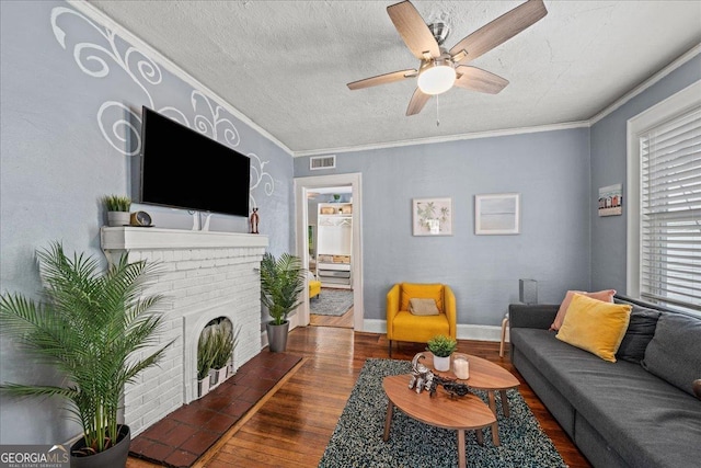 living room featuring a fireplace, ceiling fan, dark hardwood / wood-style flooring, and ornamental molding