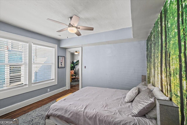 bedroom featuring ceiling fan, wood-type flooring, and a closet