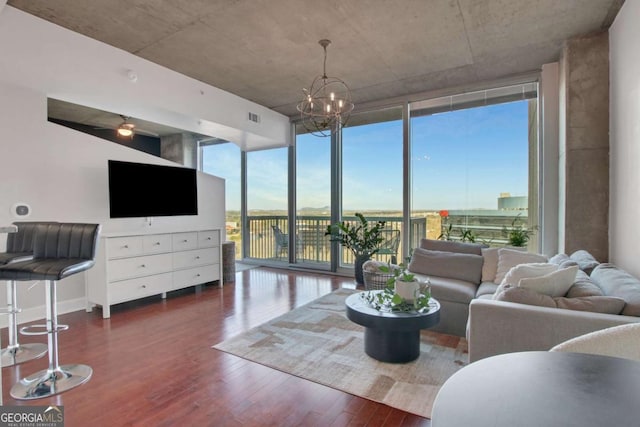 living room featuring a notable chandelier, a wall of windows, and dark hardwood / wood-style floors