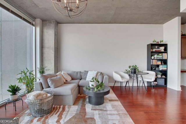 living room featuring dark hardwood / wood-style flooring and an inviting chandelier