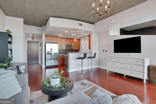 living room with dark hardwood / wood-style flooring and a chandelier