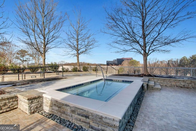 view of swimming pool featuring an in ground hot tub and a patio area