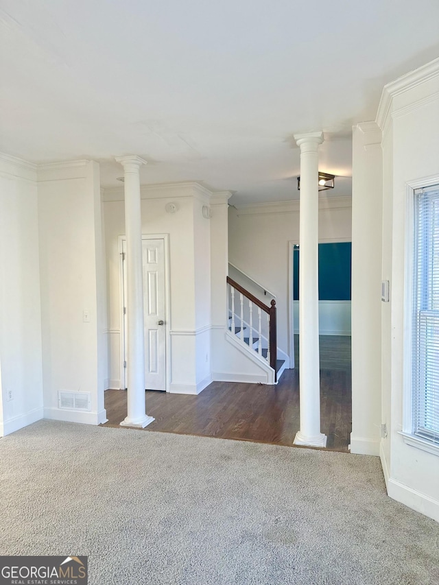 empty room with carpet floors, ornamental molding, and plenty of natural light