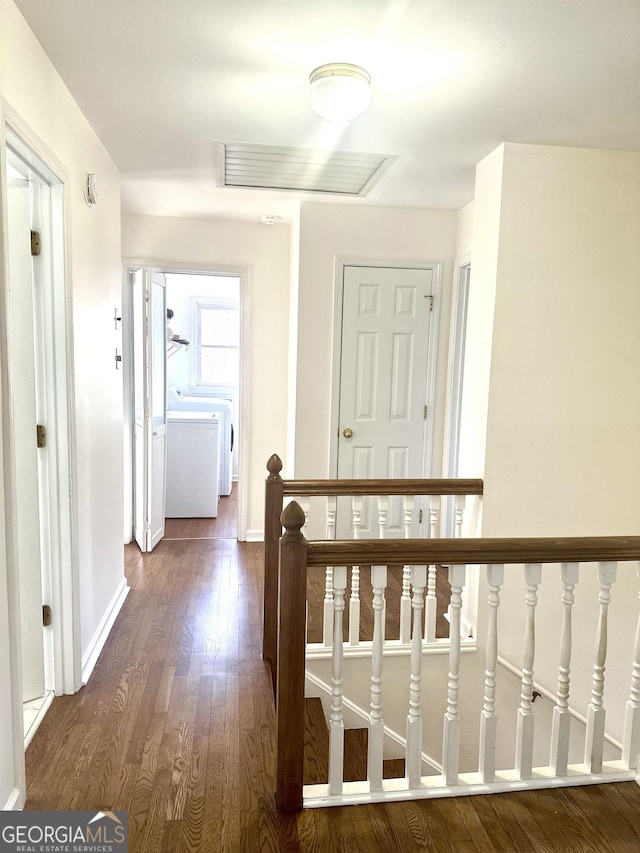 hall with washer / clothes dryer and dark hardwood / wood-style floors