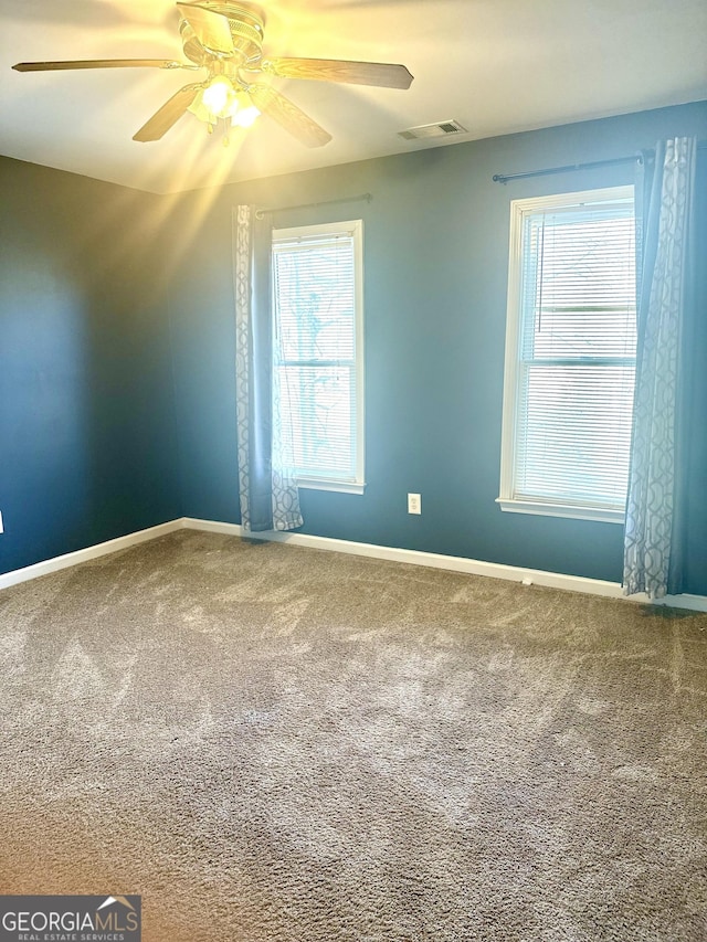 spare room with ceiling fan and carpet flooring