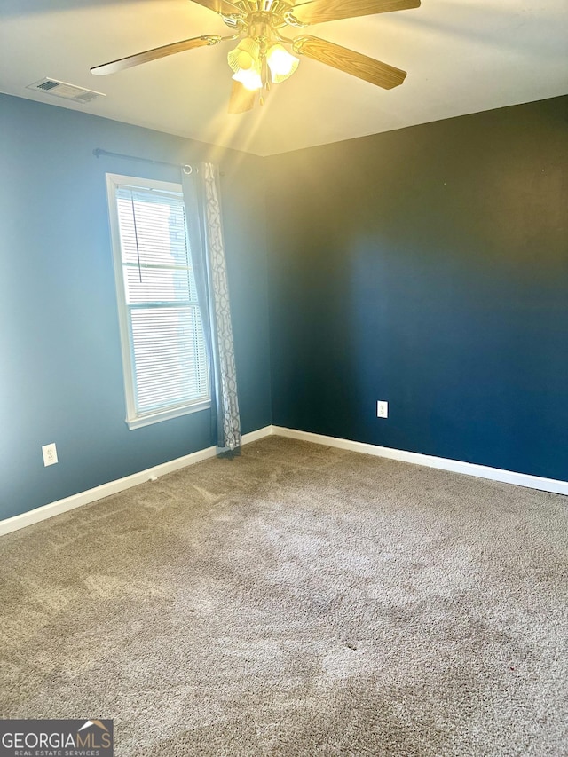 carpeted empty room featuring ceiling fan