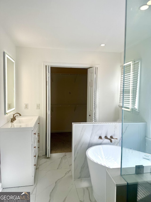 bathroom with a bath and vanity