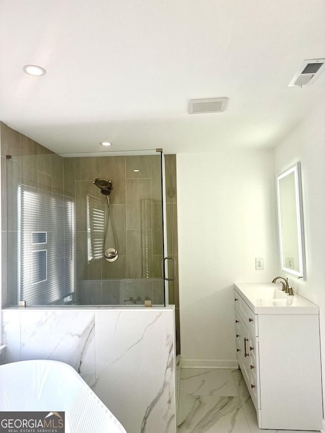 bathroom with vanity and a shower with shower door