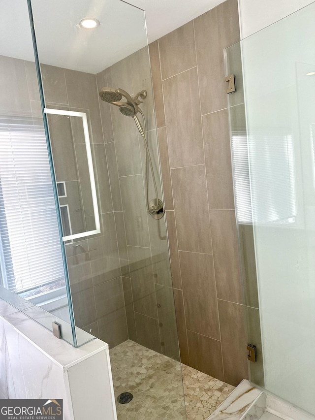 bathroom with tiled shower