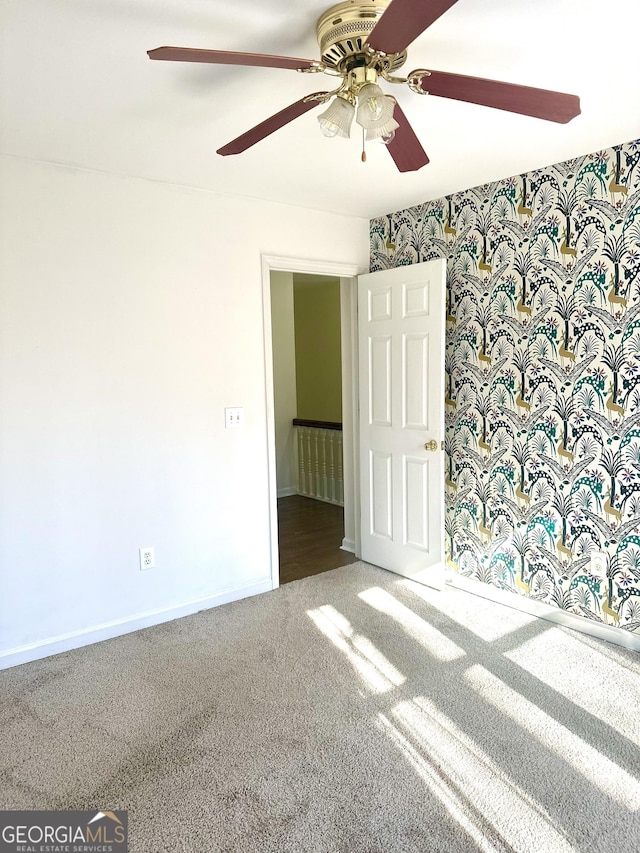 carpeted empty room with ceiling fan