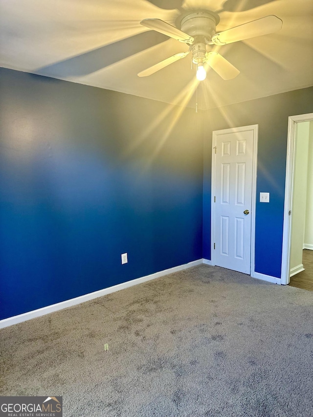 spare room with carpet flooring and ceiling fan