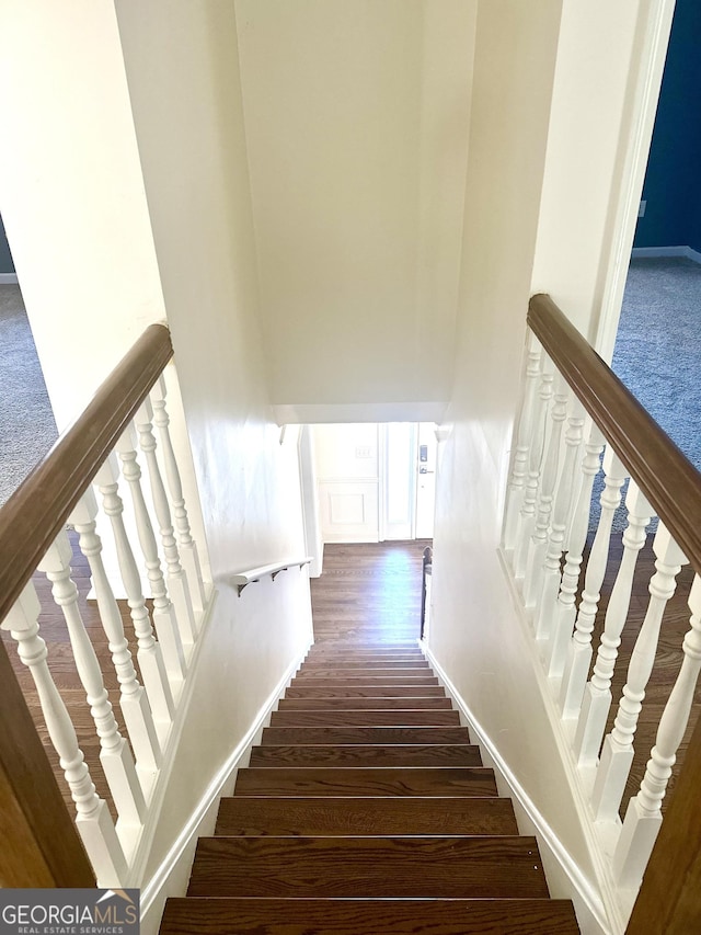 staircase featuring hardwood / wood-style flooring