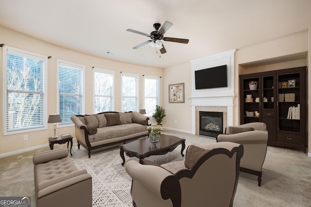 carpeted living room with ceiling fan